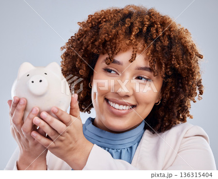 Woman with smile, piggy bank and savings in studio, finance and budget in hands with investment loan. Happiness, growth and profit inflation, salary management girl with money box on white background 136315404