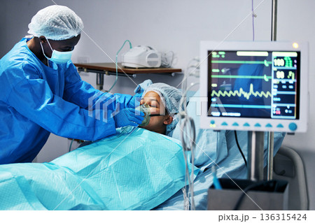 Healthcare, doctor and patient in mask for oxygen in surgery, emergency care and hospital bed. Breathing, monitor and air, surgeon helping person in operation, digital graphs to check medical results Healthcare, doctor and patient in mask for oxygen in surgery, emergency care and hospital bed. Breathing, monitor and air, surgeon helping person in operation, digital graphs to check medical results 136315424