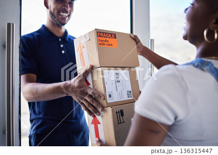 Ecommerce, delivery man with package boxes and woman at her front door for logistics. Distribution or online shopping, courier supply chain or shipping and happy man with cardboard parcel packaging 136315447
