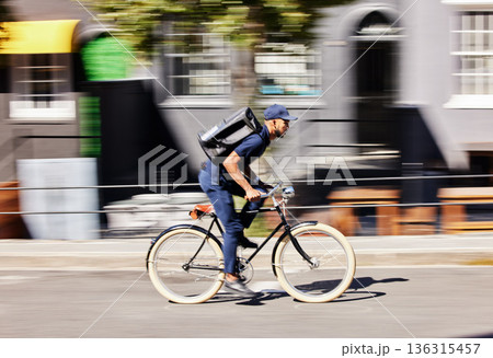 Delivery man, bicycle and motion blur in city for fast logistics, quick distribution service and order. Courier, guy or travel with speed on bike, cycle and transportation for package in urban street Delivery man, bicycle and motion blur in city for fast logistics, quick distribution service and order. Courier, guy or travel with speed on bike, cycle and transportation for package in urban street 136315457