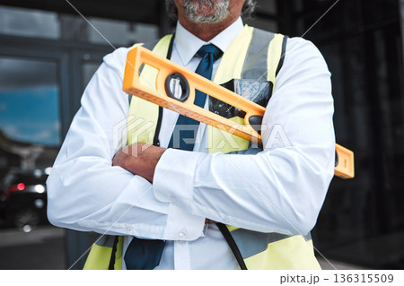 Man, arms crossed and architect has level, construction and confident in city, maintenance and project management. Urban infrastructure, architecture and male contractor with tools and professional Man, arms crossed and architect has level, construction and confident in city, maintenance and project management. Urban infrastructure, architecture and male contractor with tools and professional 136315509