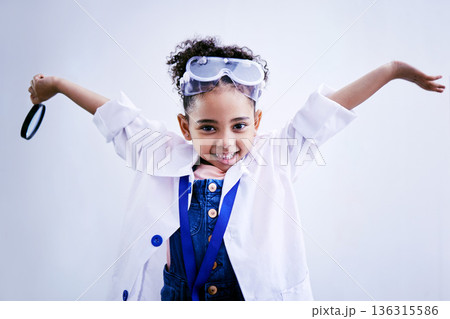Child, happy and portrait of a scientist girl in studio with open hands, glasses and a magnifier. Face of a African kid student excited for medical science, education or biology experiment for future Child, happy and portrait of a scientist girl in studio with open hands, glasses and a magnifier. Face of a African kid student excited for medical science, education or biology experiment for future 136315586