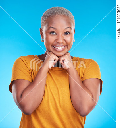 Portrait, smile and black woman with hand on face with confidence in blue studio background. Beauty, cosmetic and girl with fashion or positive mindset for wellness or happiness and excited face. Portrait, smile and black woman with hand on face with confidence in blue studio background. Beauty, cosmetic and girl with fashion or positive mindset for wellness or happiness and excited face. 136315629