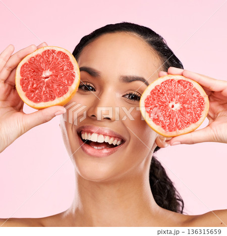 Face, grapefruit and beauty portrait of a woman with skin care, dermatology and natural glow. Happy young female aesthetic model with fruit for vitamin c, cosmetics or diet nutrition for detox Face, grapefruit and beauty portrait of a woman with skin care, dermatology and natural glow. Happy young female aesthetic model with fruit for vitamin c, cosmetics or diet nutrition for detox 136315659