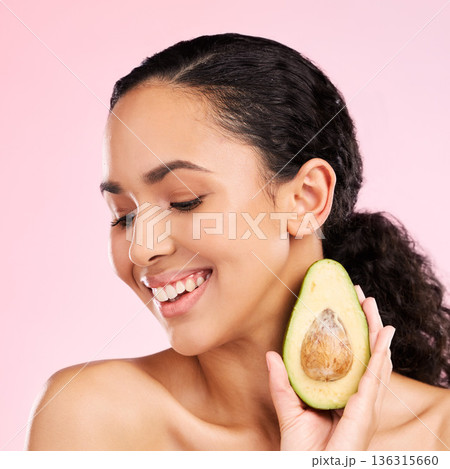 Smile, skincare and woman with avocado in studio isolated on a pink background. Happy, natural cosmetic or model with fruit, food or nutrition for healthy diet, vegan or omega 3 benefits for wellness Smile, skincare and woman with avocado in studio isolated on a pink background. Happy, natural cosmetic or model with fruit, food or nutrition for healthy diet, vegan or omega 3 benefits for wellness 136315660