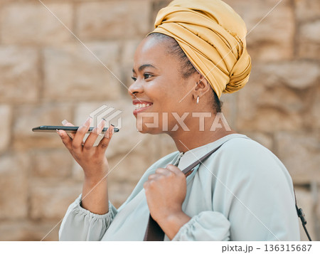 Phone, voice recognition and woman in the city walking in an urban street to her office. Technology, happy and African female designer recording a message on cellphone while commuting in town road. Phone, voice recognition and woman in the city walking in an urban street to her office. Technology, happy and African female designer recording a message on cellphone while commuting in town road. 136315687
