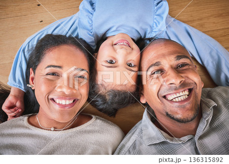 Face, family and smile in home top view, bonding and having fun on floor in house. Portrait, parents and happy child, mother and father with love, relax on ground and enjoying quality time together. Face, family and smile in home top view, bonding and having fun on floor in house. Portrait, parents and happy child, mother and father with love, relax on ground and enjoying quality time together. 136315892