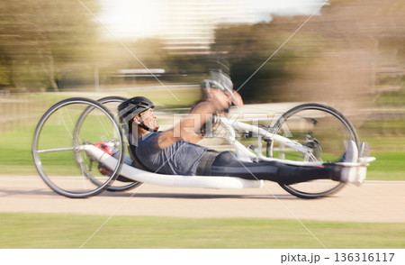 Cycling, speed and man with disability in race training for competition with action, motivation and exercise on bike. Energy, workout and person on recumbent bicycle on fast outdoor track challenge. Cycling, speed and man with disability in race training for competition with action, motivation and exercise on bike. Energy, workout and person on recumbent bicycle on fast outdoor track challenge. 136316117