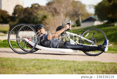Cycling, fitness and cardio with man and handcycle in nature for training, sports and challenge. Exercise, workout and marathon with person with a disability in park for wellness and health on road Cycling, fitness and cardio with man and handcycle in nature for training, sports and challenge. Exercise, workout and marathon with person with a disability in park for wellness and health on road 136316119