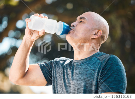 Man, drinking water and hydration in fitness after workout for nutrition, sustainability or thirst in nature. Tired and thirsty male person with healthy beverage for running, exercise or training Man, drinking water and hydration in fitness after workout for nutrition, sustainability or thirst in nature. Tired and thirsty male person with healthy beverage for running, exercise or training 136316168