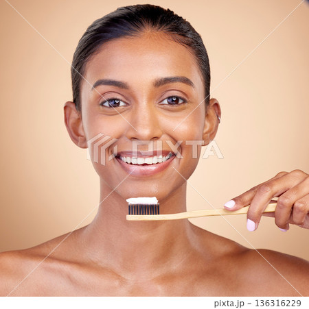 Woman, wood toothbrush and studio portrait for smile, cleaning and teeth whitening by brown background. Girl, model and happy with bamboo dentistry product, self care and cosmetic beauty with health Woman, wood toothbrush and studio portrait for smile, cleaning and teeth whitening by brown background. Girl, model and happy with bamboo dentistry product, self care and cosmetic beauty with health 136316229