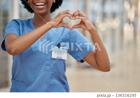 Woman, nurse and heart hands for love, healthcare or passion in cardiology at the hospital. Hand of happy female person or medical professional show loving emoji, symbol or shape icon at the clinic 136316295