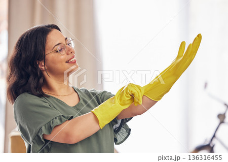 Woman, hand and gloves for cleaning service in home for safety from germs, bacteria in living room. Happy, girl and disinfect in apartment for dirt with household maintenance for dust or virus. 136316455