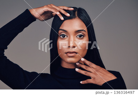 Face, beauty and skincare of confident woman in studio isolated on a gray background. Serious portrait, natural and Indian model with spa facial treatment for aesthetic, healthy skin and cosmetics. Face, beauty and skincare of confident woman in studio isolated on a gray background. Serious portrait, natural and Indian model with spa facial treatment for aesthetic, healthy skin and cosmetics. 136316497