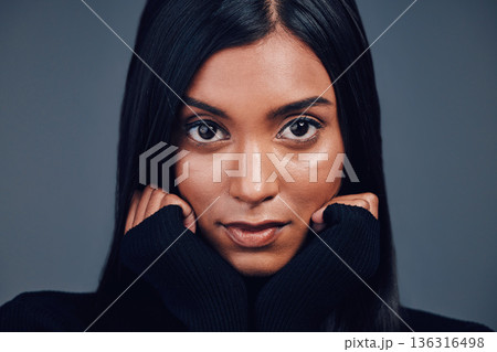 Face, beauty touch and skincare of woman in studio isolated on a gray background. Serious portrait, natural and confident Indian model with spa facial treatment for aesthetic, cosmetics and wellness. Face, beauty touch and skincare of woman in studio isolated on a gray background. Serious portrait, natural and confident Indian model with spa facial treatment for aesthetic, cosmetics and wellness. 136316498