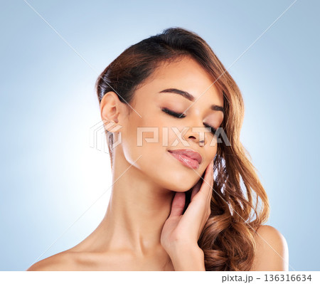 Eyes closed, beauty and woman with skincare or cosmetics in studio on blue background or relax with calm model. Face, dermatology and person with peace and wellness in salon for skin care or facial Eyes closed, beauty and woman with skincare or cosmetics in studio on blue background or relax with calm model. Face, dermatology and person with peace and wellness in salon for skin care or facial 136316634