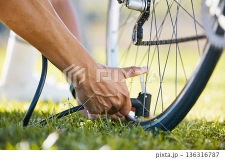 Air, bicycle and a man fixing wheel outdoor with pump or tools while cycling in nature. Bike, hands and a sports person or athlete with flat tire and maintenance, safety or repair on transportation Air, bicycle and a man fixing wheel outdoor with pump or tools while cycling in nature. Bike, hands and a sports person or athlete with flat tire and maintenance, safety or repair on transportation 136316787