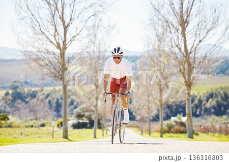 Sports, cycling and man on a bike in a park for fitness, training or morning cardio routine in nature. Bicycle, exercise and male cyclist riding on path for practice, freedom or performance challenge Sports, cycling and man on a bike in a park for fitness, training or morning cardio routine in nature. Bicycle, exercise and male cyclist riding on path for practice, freedom or performance challenge 136316803