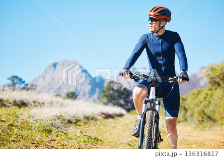 Cycling, break and man on bike in nature for fitness, sports and training, cardio or morning routine. Bicycle, freedom and male cyclist stop to rest along a dirt road while enjoying fresh air or view 136316817
