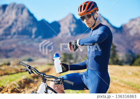 Cycling, mountain or man with a smart watch for fitness, exercise or workout goal in training. Water bottle, biker or sports athlete checking timer to monitor map progress with online app in nature 136316863