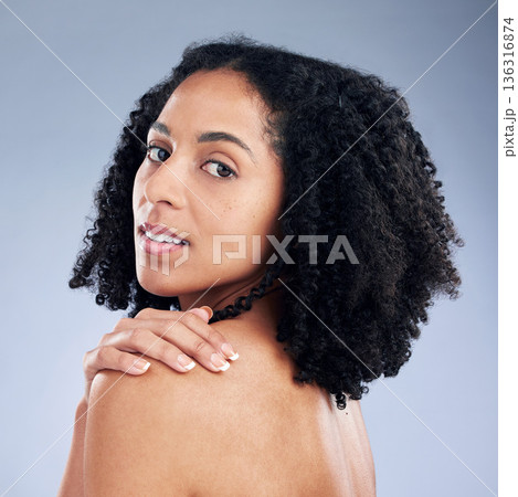 Skin care, beauty and portrait of a woman with hand on shoulder for dermatology and cosmetics. Face of a young African female model on a studio background for self love, natural glow and soft touch 136316874