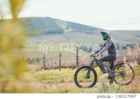 Cycling, sports and man on bicycle in countryside for training, workout and exercise in nature. Fitness, biking and male person on mountain bike for adventure, freedom and adrenaline on dirt road Cycling, sports and man on bicycle in countryside for training, workout and exercise in nature. Fitness, biking and male person on mountain bike for adventure, freedom and adrenaline on dirt road 136317007