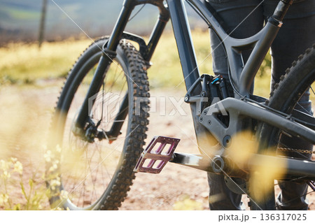 Sports, cycling and closeup of bicycle in nature for training, workout and exercise in countryside. Fitness, cyclist and person with mountain bike for adventure, freedom and ride on outdoor dirt road Sports, cycling and closeup of bicycle in nature for training, workout and exercise in countryside. Fitness, cyclist and person with mountain bike for adventure, freedom and ride on outdoor dirt road 136317025