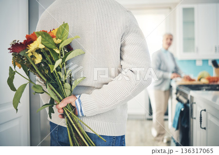 Senior, couple and flowers for love in home, kitchen or husband with bouquet of roses to surprise woman in happy marriage. Man, wife and back hiding gift, flower and romance together on anniversary Senior, couple and flowers for love in home, kitchen or husband with bouquet of roses to surprise woman in happy marriage. Man, wife and back hiding gift, flower and romance together on anniversary 136317065