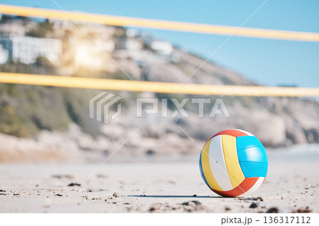 Volleyball, beach sand and net with sports and fitness, outdoor and playing game with nature and summer. Exercise, match with ball closeup and active, workout and tournament with competition Volleyball, beach sand and net with sports and fitness, outdoor and playing game with nature and summer. Exercise, match with ball closeup and active, workout and tournament with competition 136317112