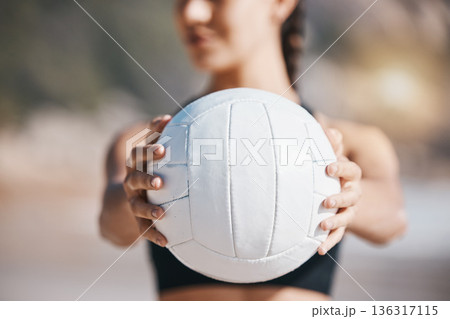 Woman, hands and volleyball in fitness for sports, game or match on beach in training or practice in nature. Hand of active and sporty female person holding ball for playing volley on ocean coast 136317115