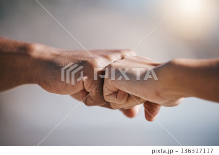 Man, hands and fist bump for teamwork, partnership or unity in solidarity or community in the outdoors. Hand of friends bumping fists together for team goals, support or motivation in collaboration 136317117