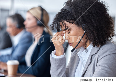 Headache, tired or woman in call center with burnout, head pain or overworked in crm communication. Migraine, office or stressed telemarketing sales agent frustrated with anxiety, fatigue or problem 136317164