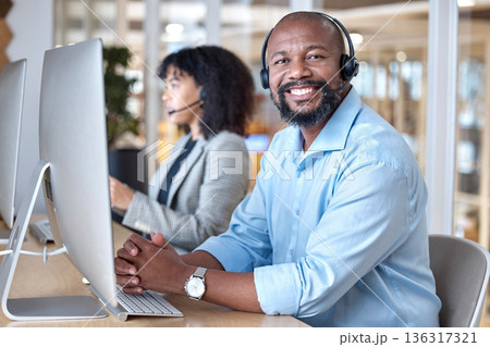 Call center, portrait of black man and smile at computer for customer service, business support and contact us in CRM office. Happy telemarketing agent at desktop for consulting in coworking agency Call center, portrait of black man and smile at computer for customer service, business support and contact us in CRM office. Happy telemarketing agent at desktop for consulting in coworking agency 136317321