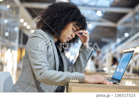 Stress, headache and woman with laptop in office, debt crisis and mental health burnout problem. Frustrated, overworked and tired African employee with tax fear, anxiety and deadline time pressure. Stress, headache and woman with laptop in office, debt crisis and mental health burnout problem. Frustrated, overworked and tired African employee with tax fear, anxiety and deadline time pressure. 136317323