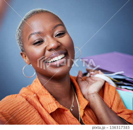 Selfie, smile and portrait of a woman with shopping bags in studio after sale, promotion or discount. Happy, excited and African female person taking picture after buying products by gray background. 136317383