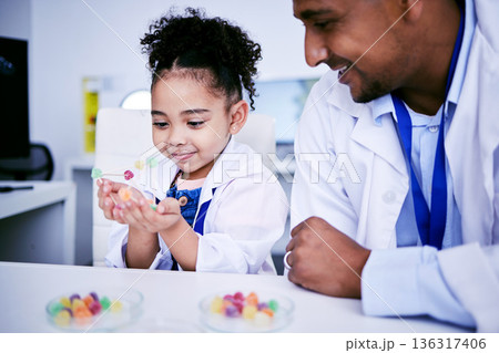 Science, research and child with her father in the lab working on an experiment or test with sweets. Biology, candy and girl kid student doing project with dad scientist in pharmaceutical laboratory. 136317406