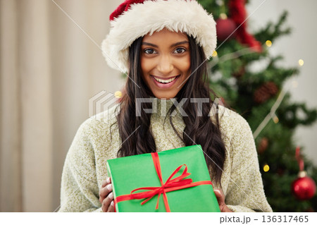 Christmas, portrait or happy woman with a gift box or present on a holiday celebration at home. Face, smile or excited Indian girl with special product or giveaway prize package in a house in winter Christmas, portrait or happy woman with a gift box or present on a holiday celebration at home. Face, smile or excited Indian girl with special product or giveaway prize package in a house in winter 136317465