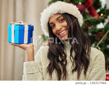 Christmas, portrait or happy girl with a gift or box in present on a holiday celebration at home run winter. Wonder, smile or excited Indian woman with present with giveaway prize package in a house Christmas, portrait or happy girl with a gift or box in present on a holiday celebration at home run winter. Wonder, smile or excited Indian woman with present with giveaway prize package in a house 136317468