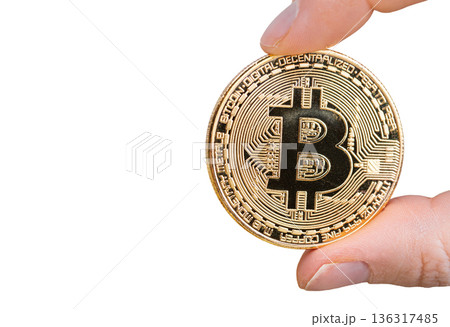 Bitcoin in female hand. Isolated on white background Bitcoin in female hand. Isolated on white background 136317485
