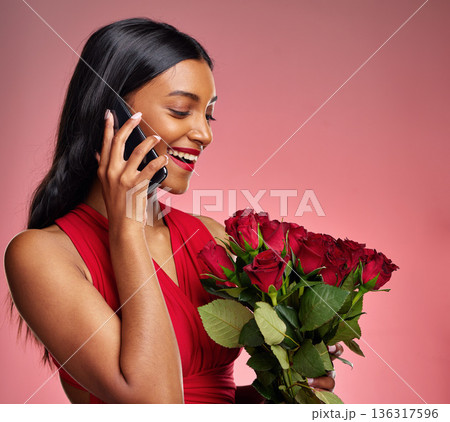 Phone call, talking and a woman with roses on a studio background for valentines day. Thank you, model and face of a young Indian girl with a flower bouquet and smartphone for romance or love on pink 136317596