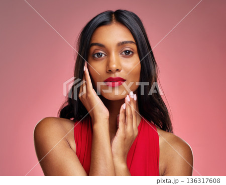Woman, portrait and face with makeup on valentines day for beauty against a studio background. Female person or model touching perfect skin in facial treatment, cosmetics or skincare of lady in red Woman, portrait and face with makeup on valentines day for beauty against a studio background. Female person or model touching perfect skin in facial treatment, cosmetics or skincare of lady in red 136317608
