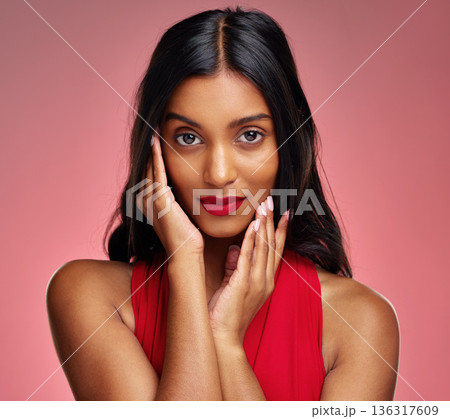 Woman, red lipstick and beauty, hands touching face with makeup and cosmetics glow on pink background. Cosmetology, Indian female model in portrait and shine with wellness and skincare in studio Woman, red lipstick and beauty, hands touching face with makeup and cosmetics glow on pink background. Cosmetology, Indian female model in portrait and shine with wellness and skincare in studio 136317609
