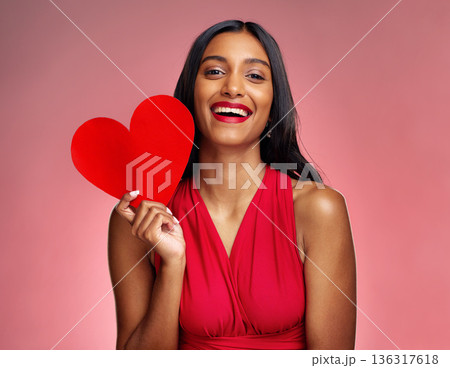 Portrait, heart and social media with a woman on a pink background in studio for love or romance. Smile, emoji and valentines day with a happy young female holding a shape or symbol of affection Portrait, heart and social media with a woman on a pink background in studio for love or romance. Smile, emoji and valentines day with a happy young female holding a shape or symbol of affection 136317618