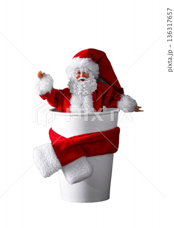 Santa Claus toy in Coffee cup with scarf, closeup. Isolated on white background. Christmas celebration. New Year holidays 136317657