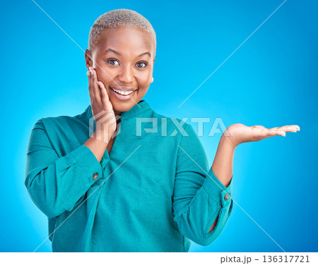 Portrait, smile and black woman showing, presentation and promotion against a blue studio background. Face, female person or model with discount deal, option and choice with decisions and advertising Portrait, smile and black woman showing, presentation and promotion against a blue studio background. Face, female person or model with discount deal, option and choice with decisions and advertising 136317721