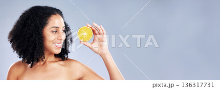 Smile, beauty and a woman with a lemon on a studio background for vitamin c and natural detox. Happy, nutrition space and a young model with fruit on a mockup banner for wellness, skincare and health Smile, beauty and a woman with a lemon on a studio background for vitamin c and natural detox. Happy, nutrition space and a young model with fruit on a mockup banner for wellness, skincare and health 136317731