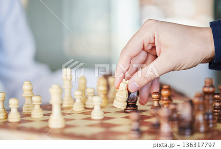 Playing, board game and chess checkmate with a man at a table while moving piece for strategy or challenge. Hands of a male person to play, relax and bond while moving icon for problem solving or win 136317797