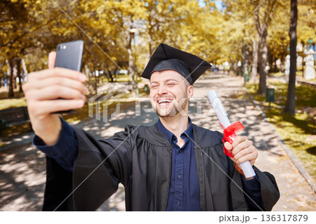 Graduation selfie, college student and man on campus, university and profile picture with diploma or certificate. Graduate success, photography and happy person in park with scholarship celebration Graduation selfie, college student and man on campus, university and profile picture with diploma or certificate. Graduate success, photography and happy person in park with scholarship celebration 136317879