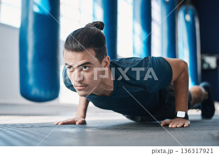 Fitness, push up or man in gym training or exercising in a workout for endurance or strong arms. Healthy person, focus or powerful sports athlete in exercise challenge for wellness or development 136317921