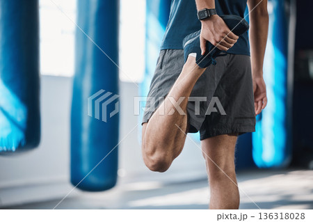 Back, fitness and stretching with a sports man in the gym getting ready for a workout or training routine. Exercise, health and warm up with a male athlete in preparation of a workout for wellness 136318028